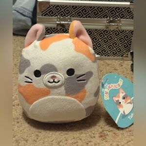 NWT cream with orange and grey speckled Squishmallows cat whose name is Tahoe
